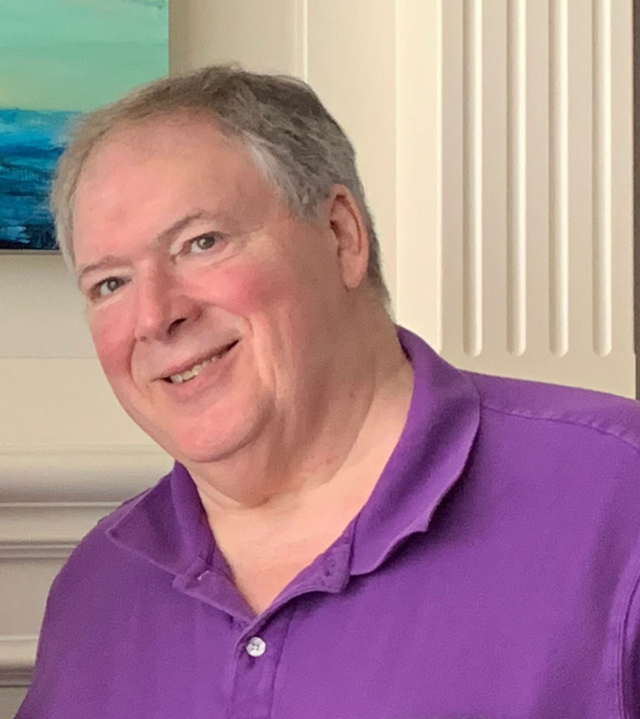 Bill smiling in a purple shirt